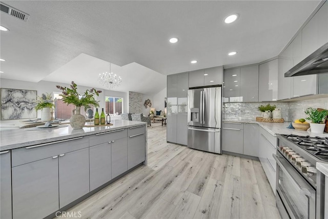39 Cape Cod, Irvine, CA 92620 - kitchen with appliances with stainless steel finishes, gray cabinets, modern cabinets, light wood finished floors, and recessed lighting