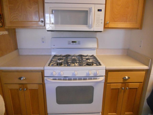 955 Howard Ave Unit 40, Escondido, CA 92029 - kitchen featuring white appliances, light countertops, and brown cabinetry