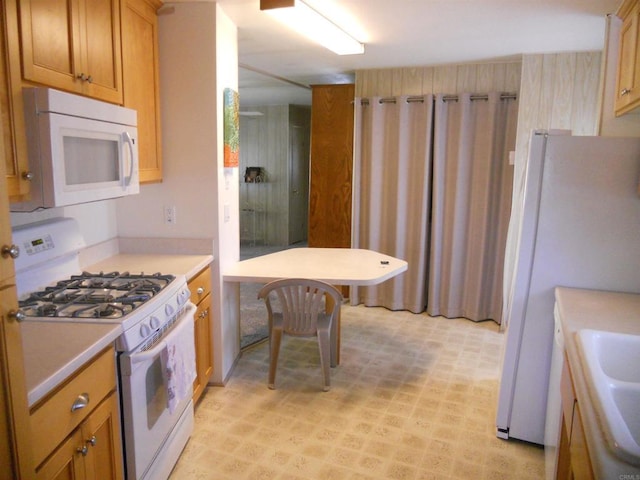 955 Howard Ave Unit 40, Escondido, CA 92029 - kitchen featuring white appliances, light countertops, light floors, and brown cabinets