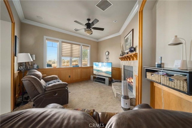 35655 52nd St E, Palmdale, CA 93552 - living room featuring carpet flooring, crown molding, a fireplace, ceiling fan, and a wainscoted wall