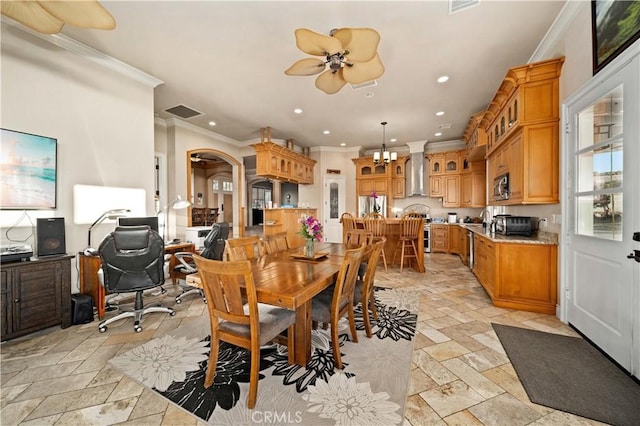 35655 52nd St E, Palmdale, CA 93552 - dining area with crown molding, stone tile floors, recessed lighting, ceiling fan, and arched walkways