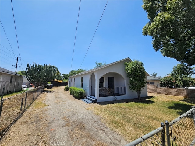 26483 9th St, Highland, CA 92346 - view of front of home featuring driveway, stucco siding, and a porch