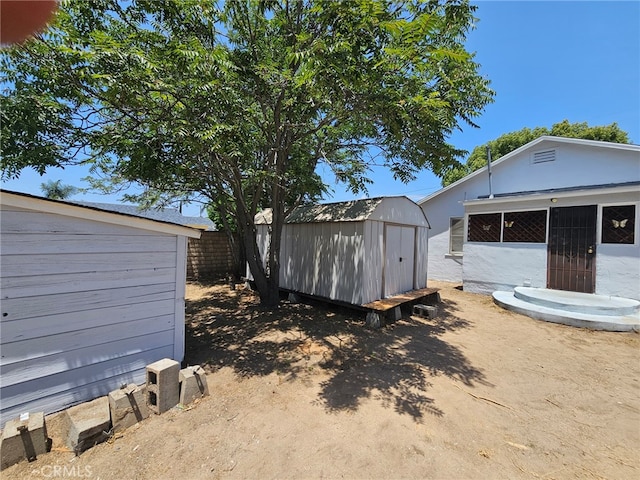 26483 9th St, Highland, CA 92346 - view of yard featuring a storage unit