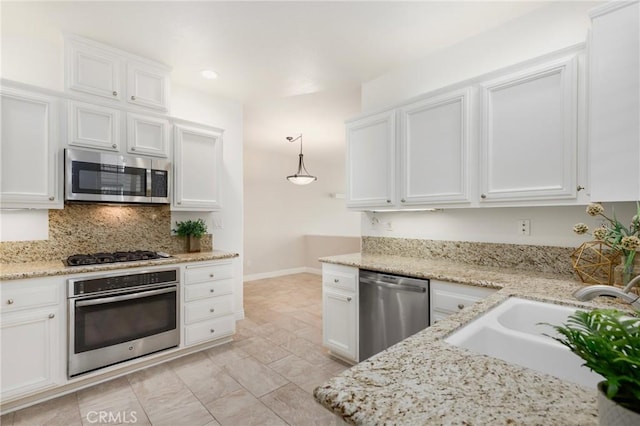 5527 Patricia Way, Yorba Linda, CA 92887 - kitchen with stainless steel appliances, white cabinetry, decorative backsplash, recessed lighting, and light stone countertops