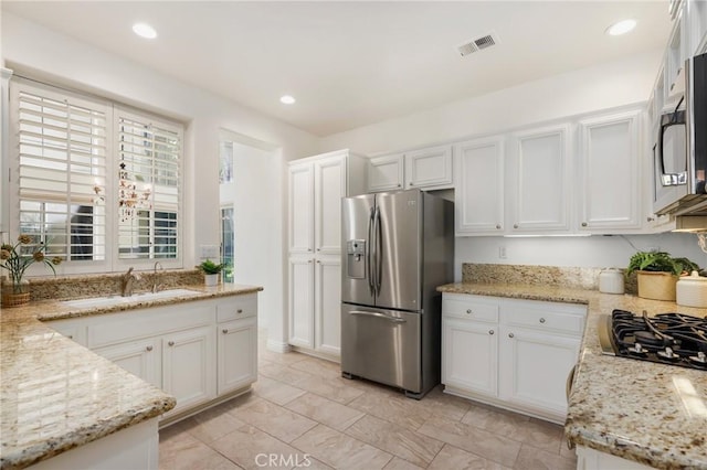 5527 Patricia Way, Yorba Linda, CA 92887 - kitchen featuring appliances with stainless steel finishes, white cabinetry, light stone counters, and recessed lighting