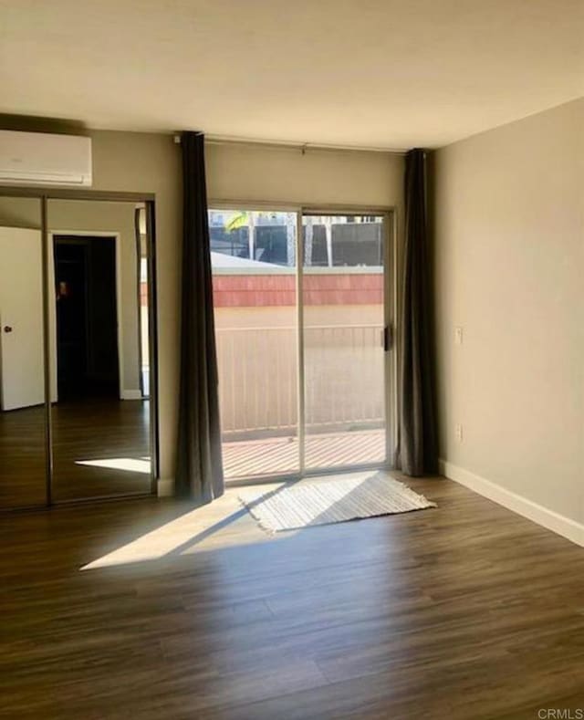 2330 Hosp Way Unit 303, Carlsbad, CA 92008 - spare room featuring an AC wall unit and wood finished floors
