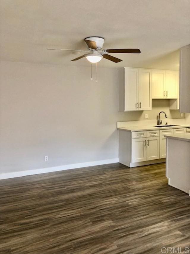 2330 Hosp Way Unit 303, Carlsbad, CA 92008 - kitchen featuring white cabinets, light countertops, dark wood-style flooring, and ceiling fan