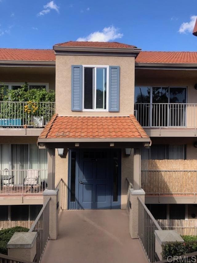 2330 Hosp Way Unit 303, Carlsbad, CA 92008 - view of front of property with a balcony, stucco siding, and a tile roof