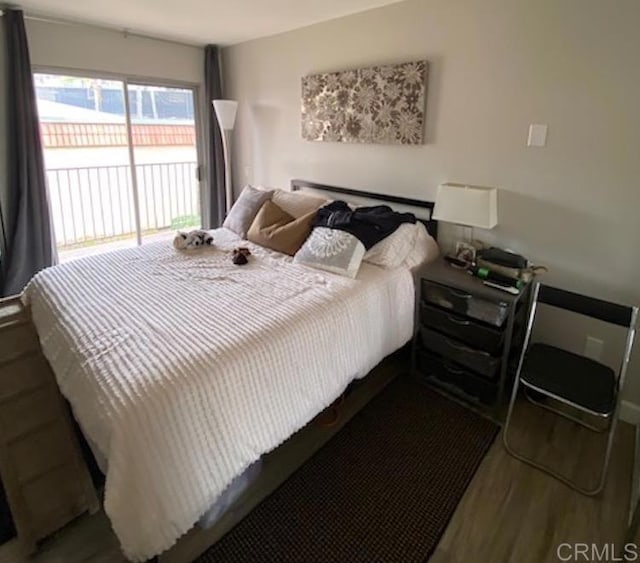 2330 Hosp Way Unit 303, Carlsbad, CA 92008 - bedroom with wood finished floors and access to outside