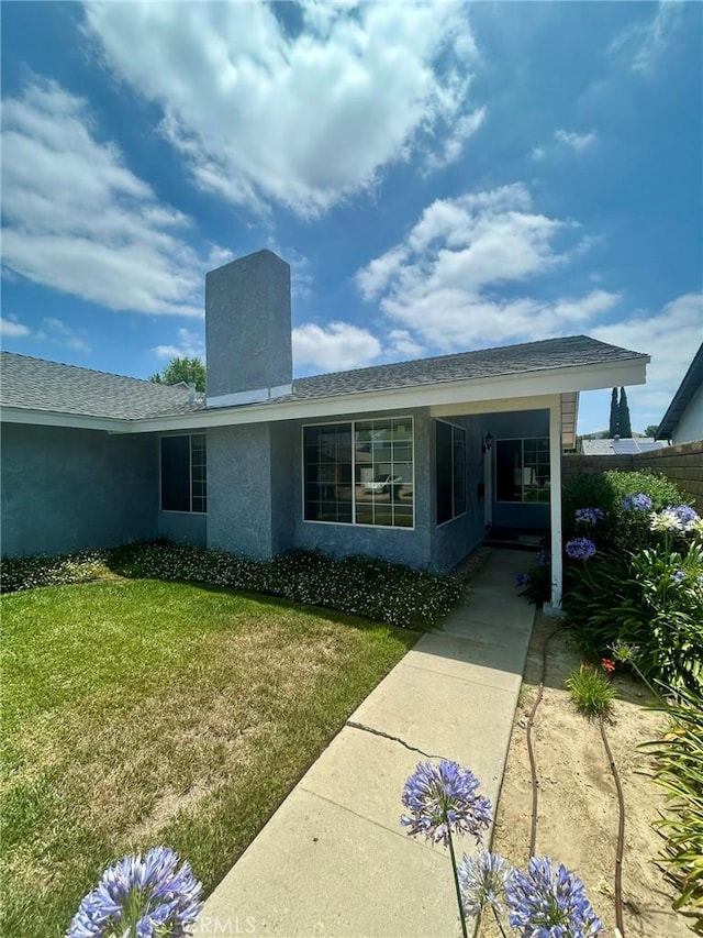 3964 Hibbert Ct, Simi Valley, CA 93063 - view of exterior entry featuring a lawn and stucco siding