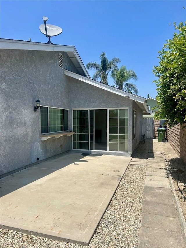 3964 Hibbert Ct, Simi Valley, CA 93063 - rear view of property featuring stucco siding, a patio area, and a gate
