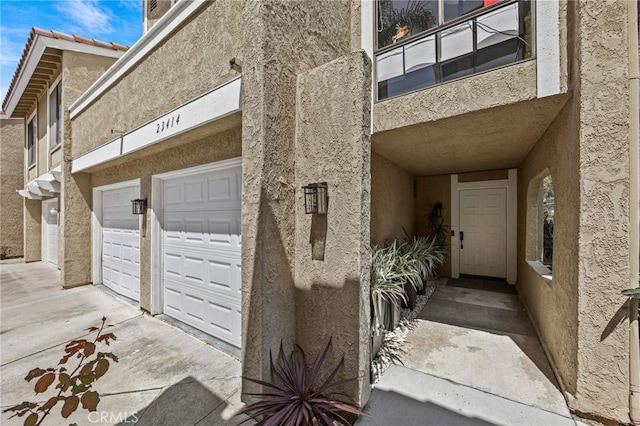 23414 Highcrest Rd, Dana Point, CA 92629 - entrance to property featuring stucco siding, a garage, and driveway