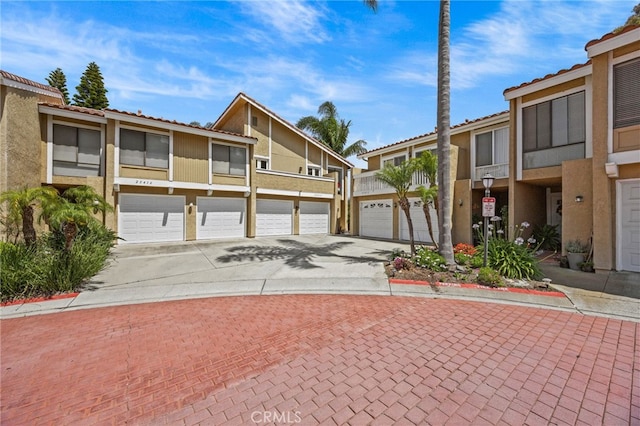 23414 Highcrest Rd, Dana Point, CA 92629 - townhome / multi-family property with driveway, stucco siding, a garage, and a tile roof