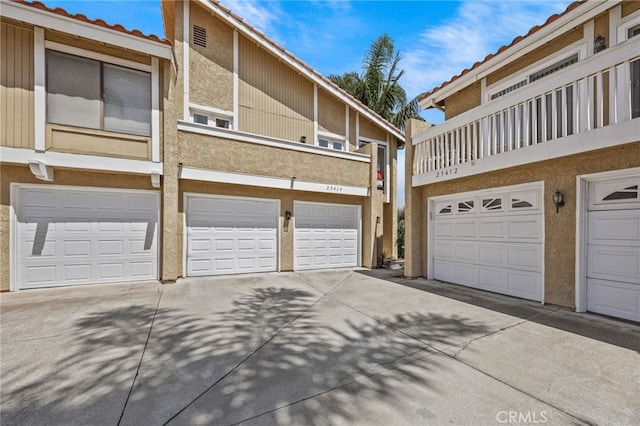 23414 Highcrest Rd, Dana Point, CA 92629 - rear view of property featuring a tile roof, stucco siding, a balcony, and driveway