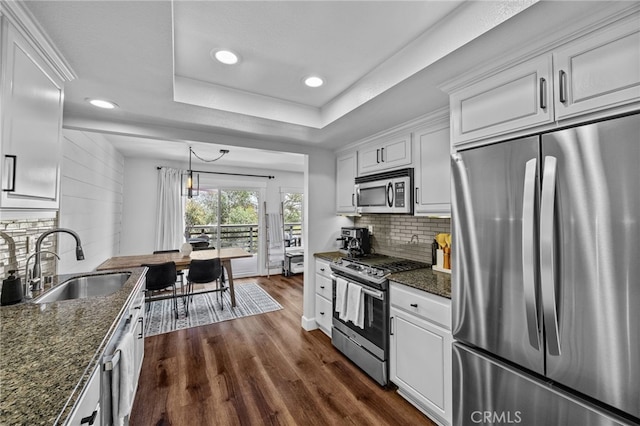 23414 Highcrest Rd, Dana Point, CA 92629 - kitchen with stainless steel appliances, recessed lighting, white cabinetry, dark wood finished floors, and tasteful backsplash