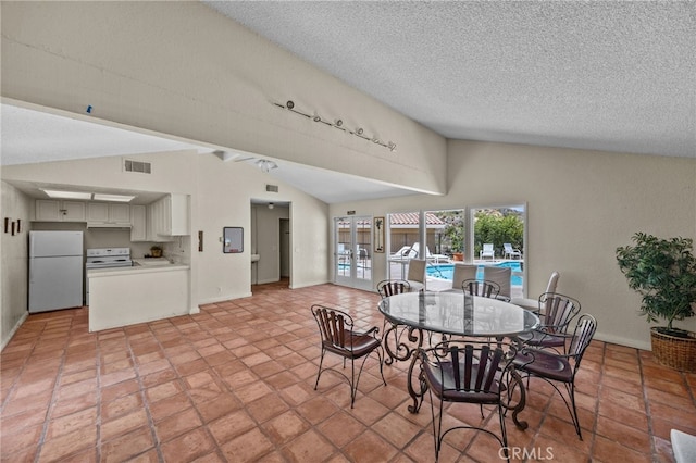 23414 Highcrest Rd, Dana Point, CA 92629 - dining room featuring lofted ceiling, a textured ceiling, and rail lighting