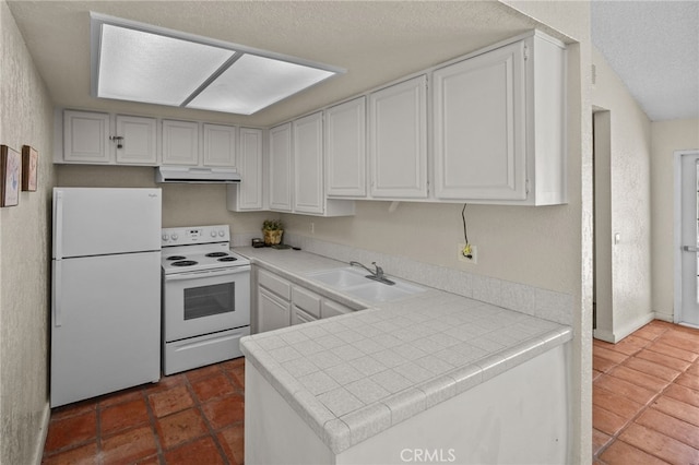 23414 Highcrest Rd, Dana Point, CA 92629 - kitchen with white appliances, under cabinet range hood, tile countertops, a peninsula, and white cabinetry