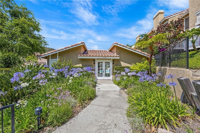 23414 Highcrest Rd, Dana Point, CA 92629 - view of front facade with french doors, a tile roof, and stucco siding