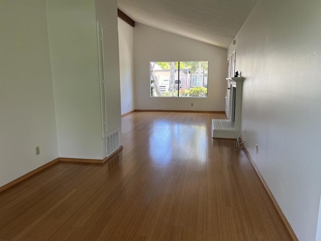 1404 Lombard St, Vista, CA 92084 - unfurnished living room featuring vaulted ceiling and wood finished floors