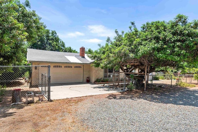 16805 Duckworth Ave, Riverside, CA 92504 - view of front facade featuring an attached garage, driveway, a chimney, and stucco siding