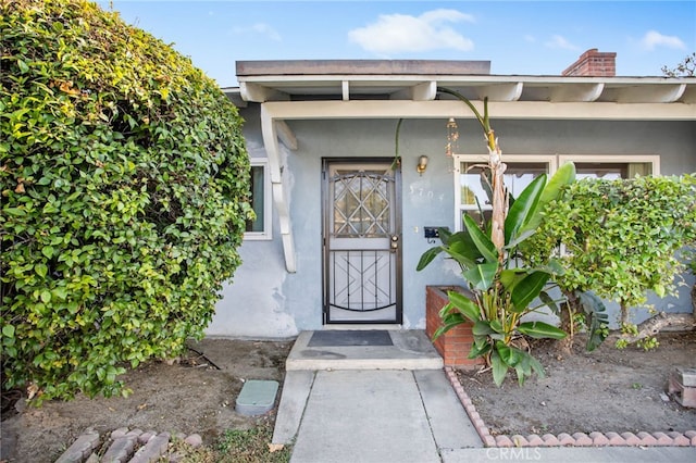 3704 La Sierra Ave, Riverside, CA 92505 - view of exterior entry with a chimney and stucco siding