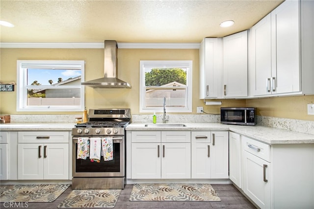 3704 La Sierra Ave, Riverside, CA 92505 - kitchen featuring wall chimney exhaust hood, gas stove, a textured ceiling, white cabinets, and ornamental molding