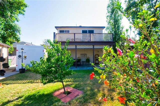 30 N Vega St, Alhambra, CA 91801 - rear view of property featuring stucco siding and a yard