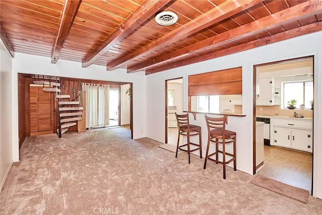 30 N Vega St, Alhambra, CA 91801 - kitchen with light carpet, a wood ceiling with exposed beams, white cabinetry, healthy amount of natural light, and a breakfast bar