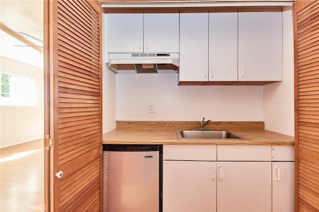 30 N Vega St, Alhambra, CA 91801 - kitchen with under cabinet range hood, dishwashing machine, white cabinetry, light countertops, and wood finished floors
