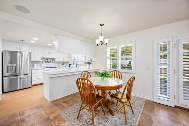 19177 White Dove Ln, Riverside, CA 92508 - dining space with healthy amount of natural light, a chandelier, recessed lighting, and light tile patterned flooring