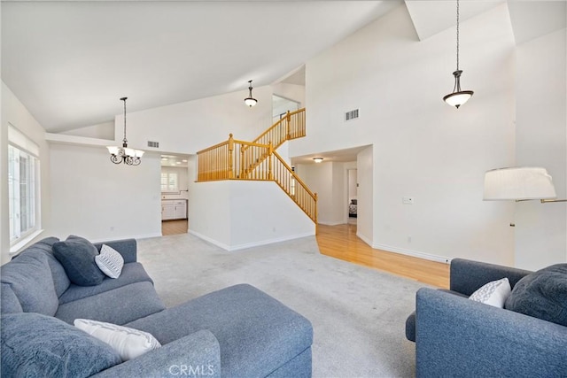 19177 White Dove Ln, Riverside, CA 92508 - living area with stairs, carpet floors, a chandelier, and high vaulted ceiling