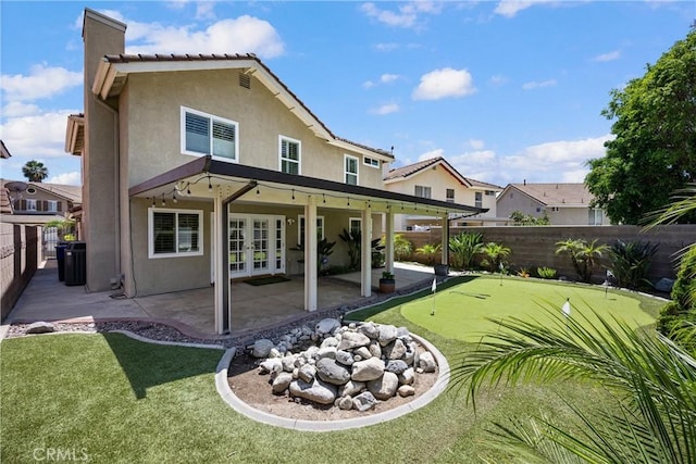 19177 White Dove Ln, Riverside, CA 92508 - back of house featuring a putting green, french doors, stucco siding, and a patio