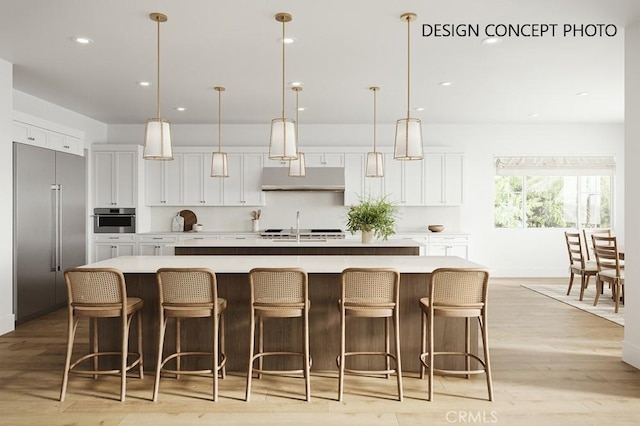 1716 6th St, Manhattan Beach, CA 90266 - kitchen featuring appliances with stainless steel finishes, white cabinets, a large island with sink, decorative light fixtures, and recessed lighting