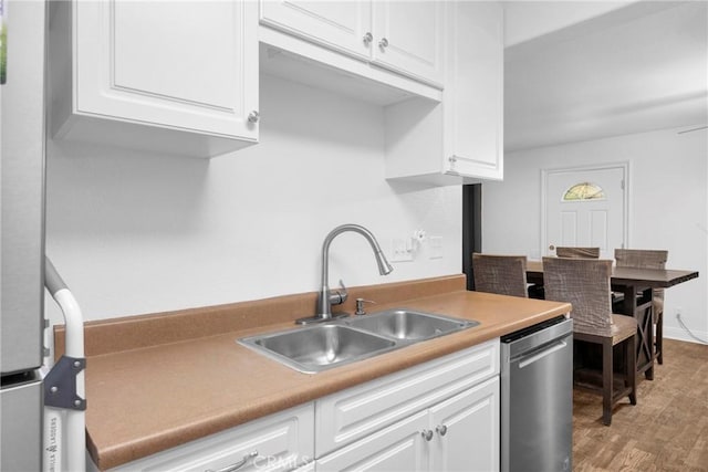 382 S Miraleste Dr Unit 450, San Pedro, CA 90732 - kitchen with dishwasher, white cabinetry, wood finished floors, and light countertops