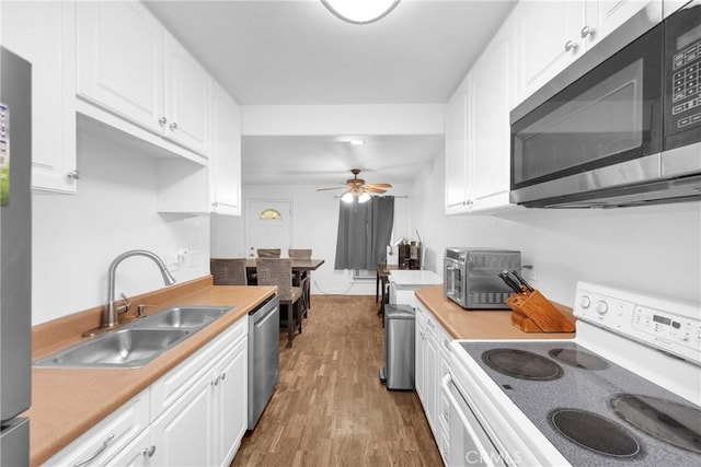 382 S Miraleste Dr Unit 450, San Pedro, CA 90732 - kitchen with stainless steel appliances, light countertops, and white cabinets