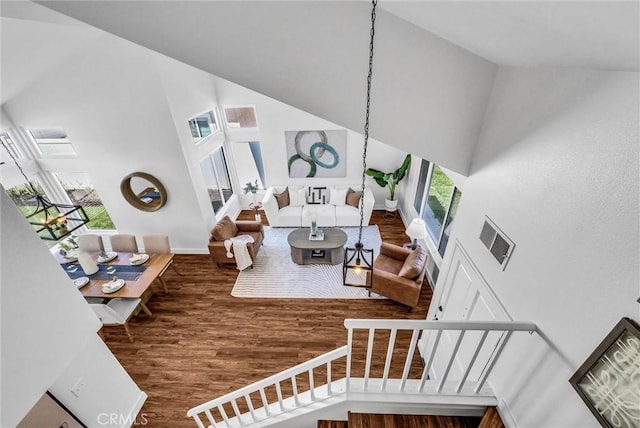 1251 Mayfair Dr, Corona, CA 92882 - living area with high vaulted ceiling, wood finished floors, and stairs
