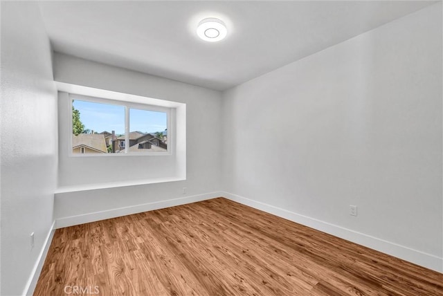1251 Mayfair Dr, Corona, CA 92882 - empty room with wood finished floors and baseboards