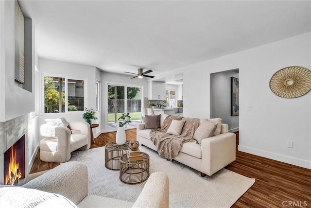 1251 Mayfair Dr, Corona, CA 92882 - living area featuring a premium fireplace, ceiling fan, and wood finished floors