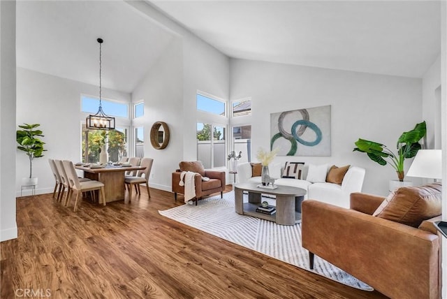 1251 Mayfair Dr, Corona, CA 92882 - living room with wood finished floors, high vaulted ceiling, and a chandelier