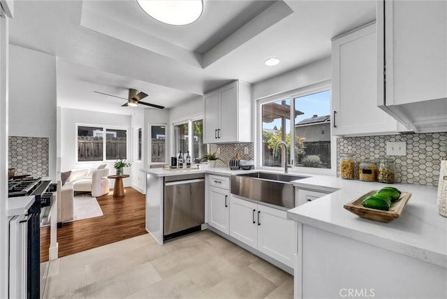1251 Mayfair Dr, Corona, CA 92882 - kitchen with appliances with stainless steel finishes, open floor plan, decorative backsplash, light countertops, and recessed lighting