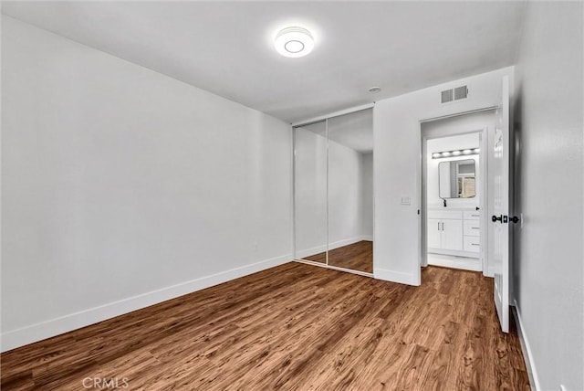 1251 Mayfair Dr, Corona, CA 92882 - unfurnished bedroom featuring wood finished floors and a closet