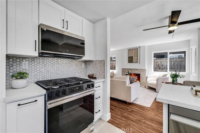 1251 Mayfair Dr, Corona, CA 92882 - kitchen with appliances with stainless steel finishes, light countertops, and white cabinetry