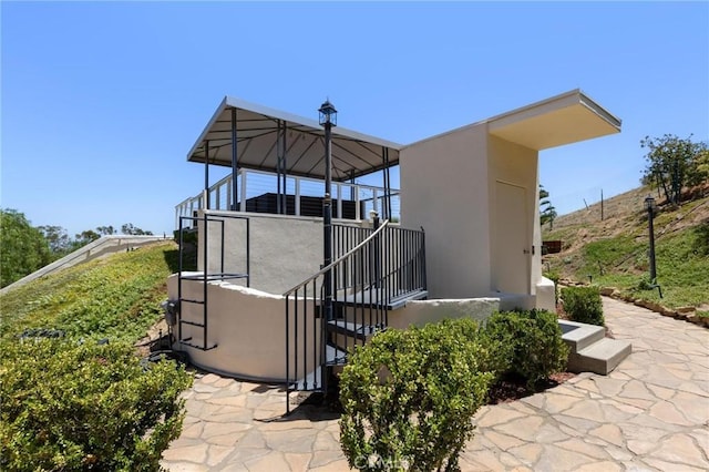 22870 Trigger St, Chatsworth, CA 91311 - back of house with stairs and stucco siding