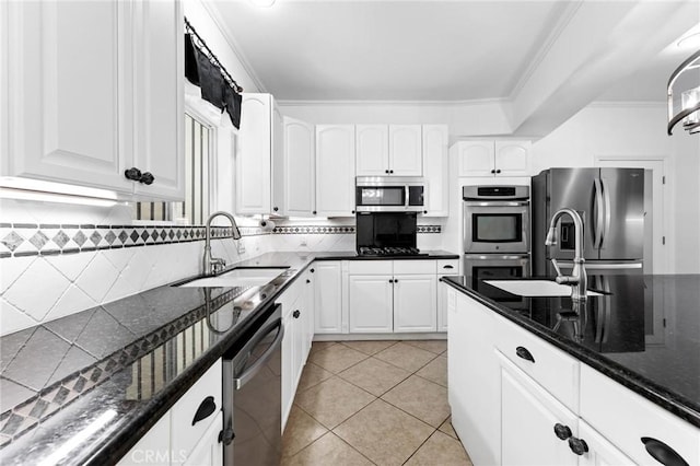 22870 Trigger St, Chatsworth, CA 91311 - kitchen featuring stainless steel appliances, crown molding, white cabinets, tasteful backsplash, and dark stone countertops