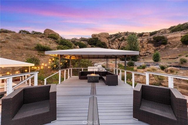 22870 Trigger St, Chatsworth, CA 91311 - deck at dusk with a gazebo and an outdoor living space