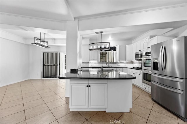 22870 Trigger St, Chatsworth, CA 91311 - kitchen with appliances with stainless steel finishes, dark countertops, light tile patterned floors, white cabinets, and ornamental molding