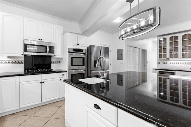 22870 Trigger St, Chatsworth, CA 91311 - kitchen with stainless steel appliances, backsplash, ornamental molding, glass insert cabinets, and dark stone countertops