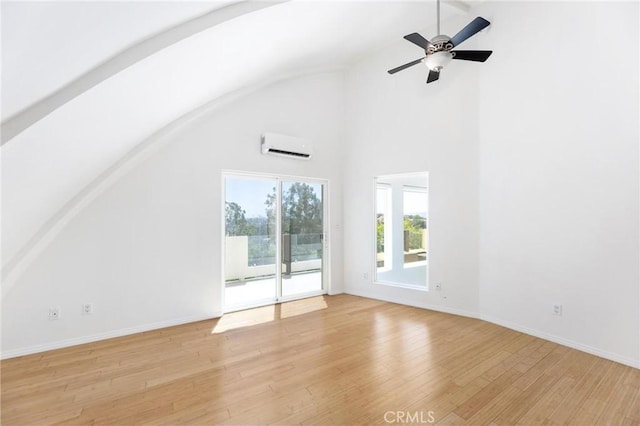 22870 Trigger St, Chatsworth, CA 91311 - unfurnished living room with lofted ceiling, light wood finished floors, a wall unit AC, and a ceiling fan