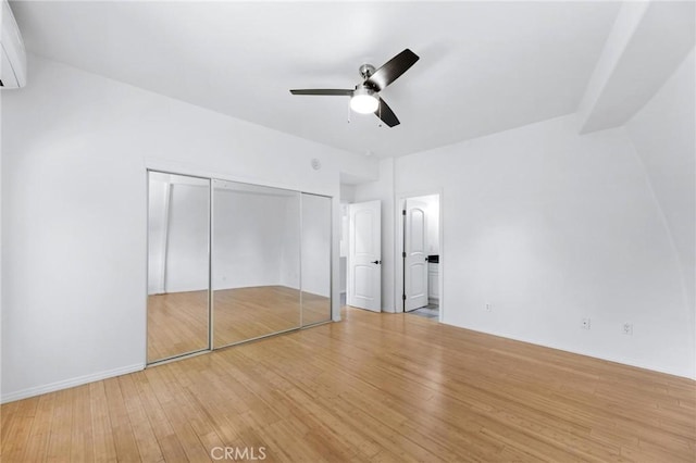 22870 Trigger St, Chatsworth, CA 91311 - unfurnished bedroom featuring wood finished floors, a ceiling fan, and a wall mounted air conditioner