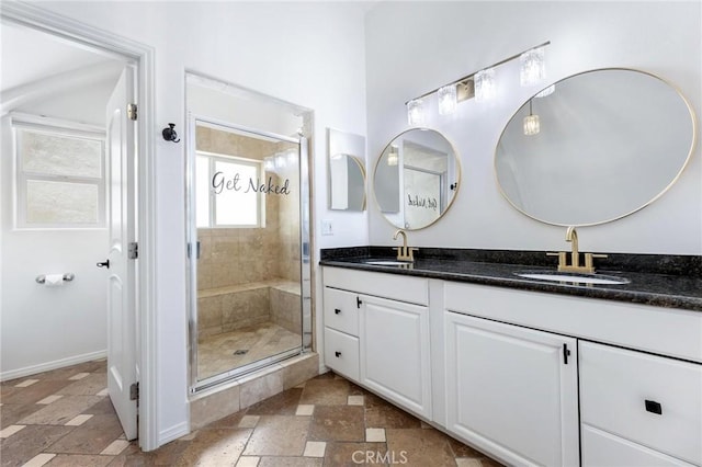 22870 Trigger St, Chatsworth, CA 91311 - full bath with double vanity, stone tile flooring, and a stall shower